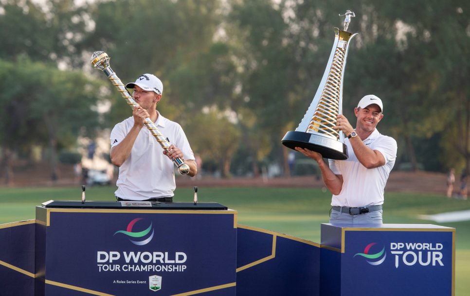 NICOLAI HoJGAARD of Denmark kisses the trophy after winning DP World Tour Championship, while RORY MCILROY of Northern I